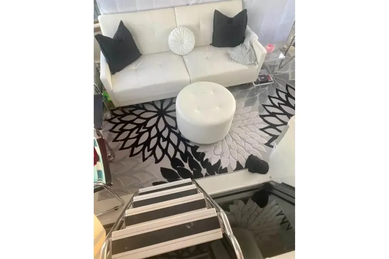 Slide: The Image of Interior of 1991 Silverton 41 Motor Yacht with modern decor and floral rug. - 70