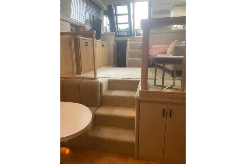 Slide: The Image of Interior of 1991 Silverton 41 Motor Yacht with carpeted stairs and cozy seating area. - 72