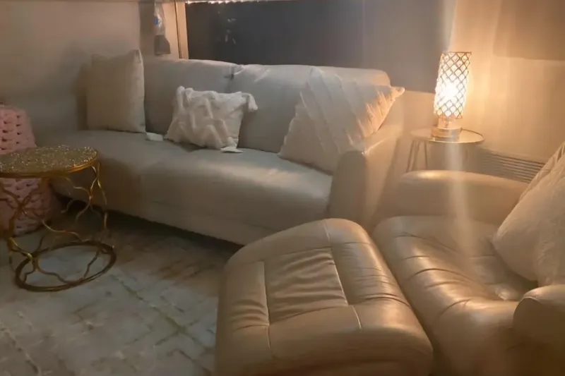 Slide: The Image of Cozy interior of 1991 Silverton 41 Motor Yacht with sofa, armchair, and decorative lighting. - 73