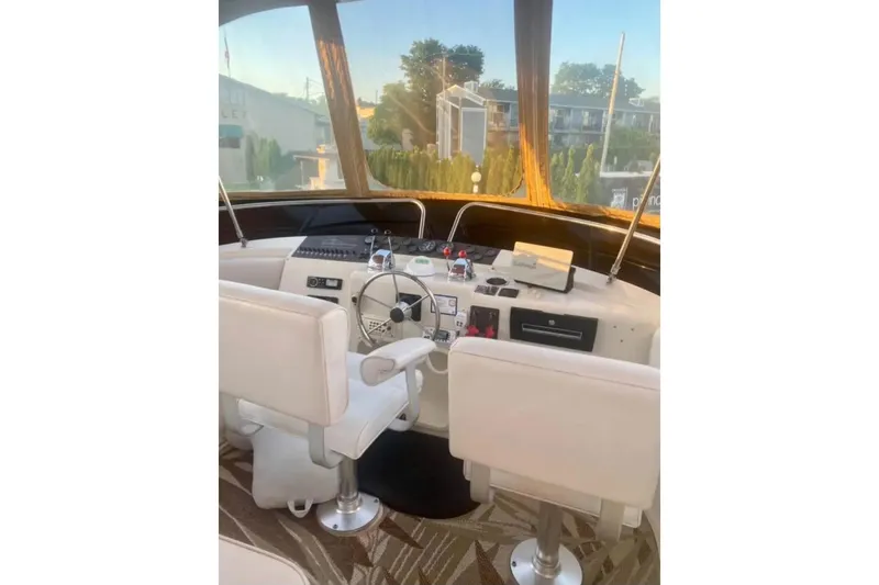 Slide: The Image of 1991 Silverton 41 Motor Yacht helm with dual seats and navigation controls. - 74