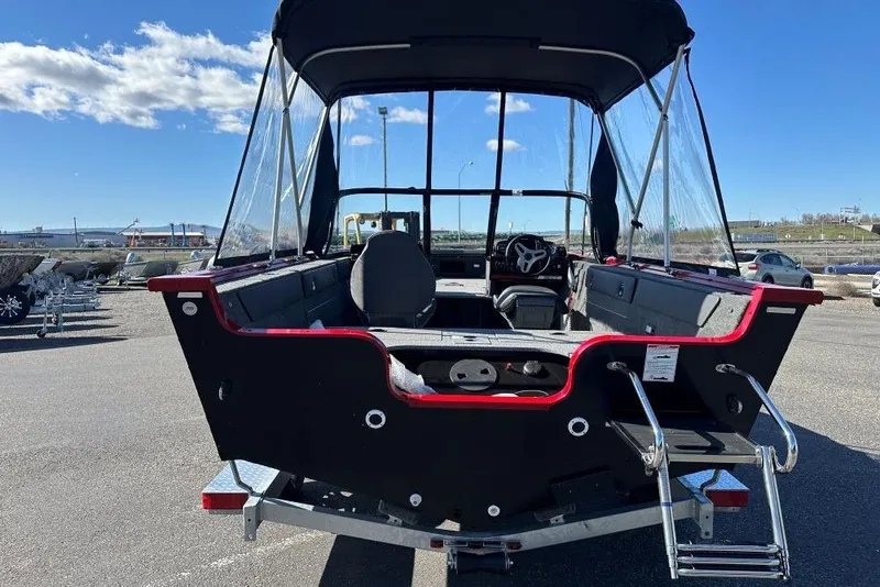 Slide: The Image of 2026 Starweld 17 SXT boat with canopy, parked on a sunny day. - 3