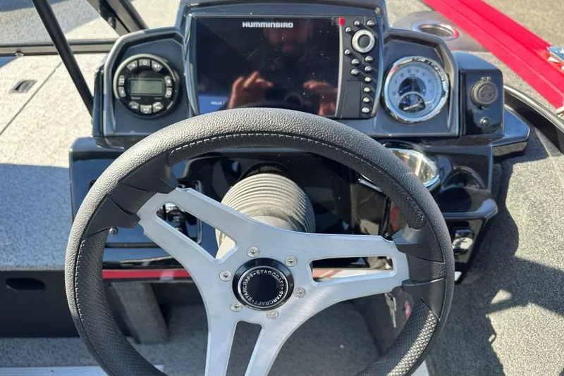 Slide: The Image of Steering wheel and dashboard of 2026 Starweld 17 SXT boat with navigation controls. - 5