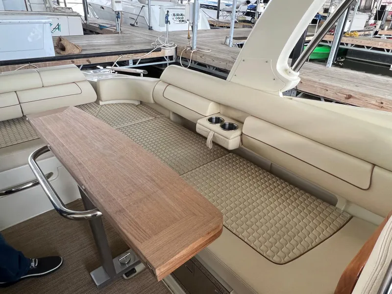 Slide: The Image of 2020 Chris-Craft Launch 31 GT interior with beige seating and wooden table. - 14