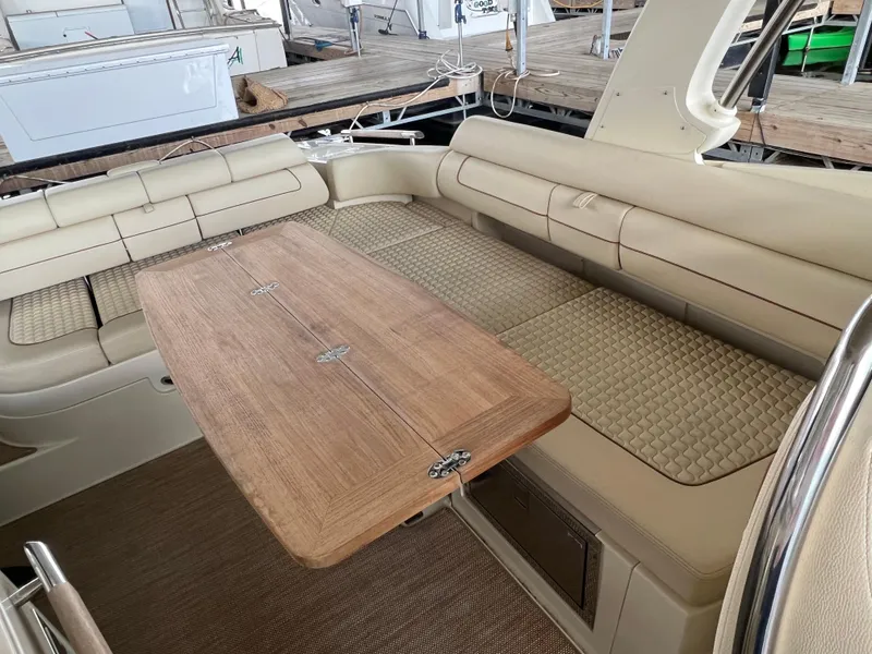 Slide: The Image of 2020 Chris-Craft Launch 31 GT interior with beige seating and wooden table. - 16