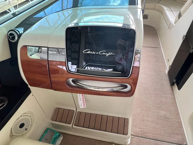 Slide: The Image of 2020 Chris-Craft Launch 31 GT dashboard with wood accents and modern controls. - 22