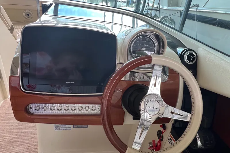 Slide: The Image of Chris-Craft Launch 31 GT 2020 dashboard with steering wheel and Garmin display. - 23