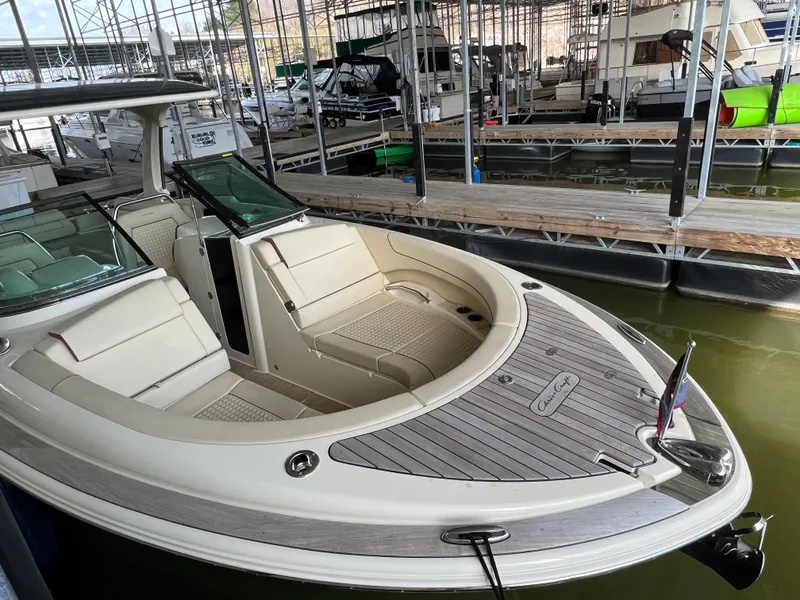 Slide: The Image of 2020 Chris-Craft Launch 31 GT docked in a marina, showcasing its luxurious seating and sleek design. - 26