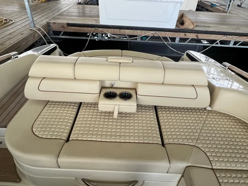 Slide: The Image of 2020 Chris-Craft Launch 31 GT boat with beige cushioned seating and cup holders. - 29