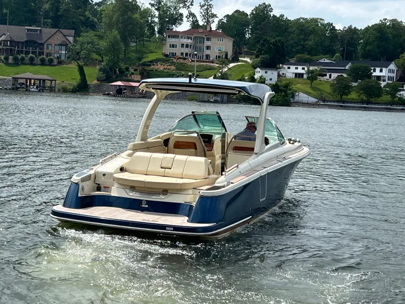 Slide: The Image of 2020 Chris-Craft Launch 31 GT boat cruising on a scenic lake. - 5