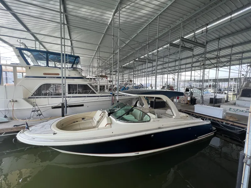 Slide: The Image of 2020 Chris-Craft Launch 31 GT boat docked in a covered marina. - 6