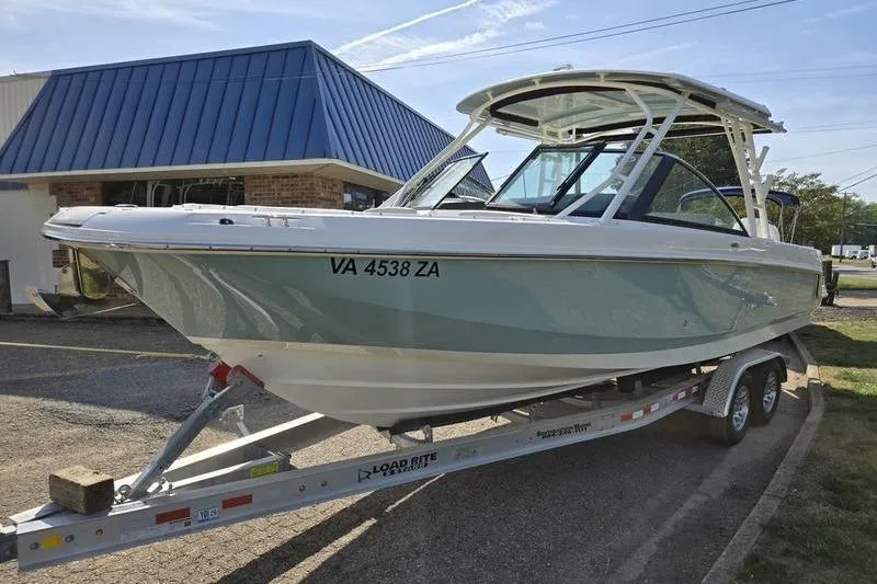 Slide: The Image of 2020 Boston Whaler 270 Vantage boat on trailer, parked outside a building. - 11