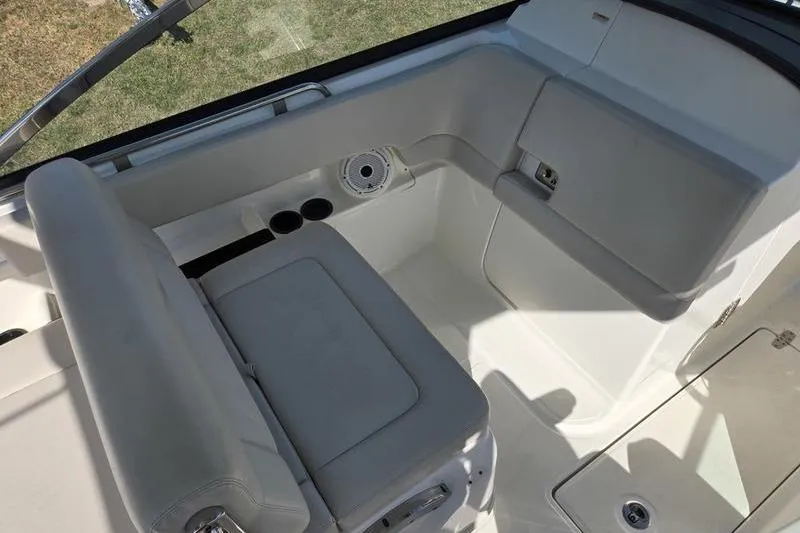 Slide: The Image of 2020 Boston Whaler 270 Vantage interior seating area with cup holders and speaker. - 12