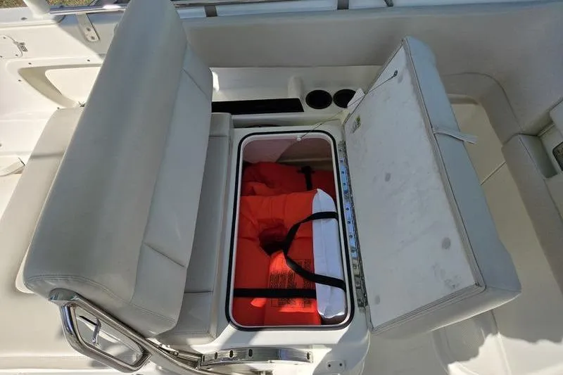 Slide: The Image of 2020 Boston Whaler 270 Vantage boat seat storage with life jackets inside. - 13