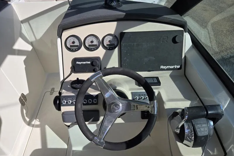 Slide: The Image of Cockpit of 2020 Boston Whaler 270 Vantage with Raymarine navigation system and steering wheel. - 14