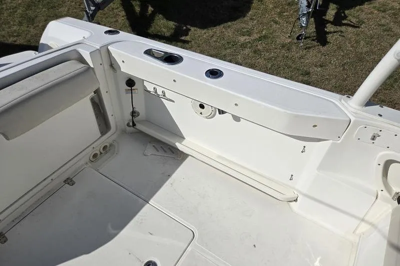 Slide: The Image of 2020 Boston Whaler 270 Vantage boat interior, featuring white seating and storage compartments. - 15