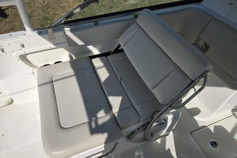 Slide: The Image of 2020 Boston Whaler 270 Vantage interior seating, featuring white cushioned seats and stainless steel frame. - 16