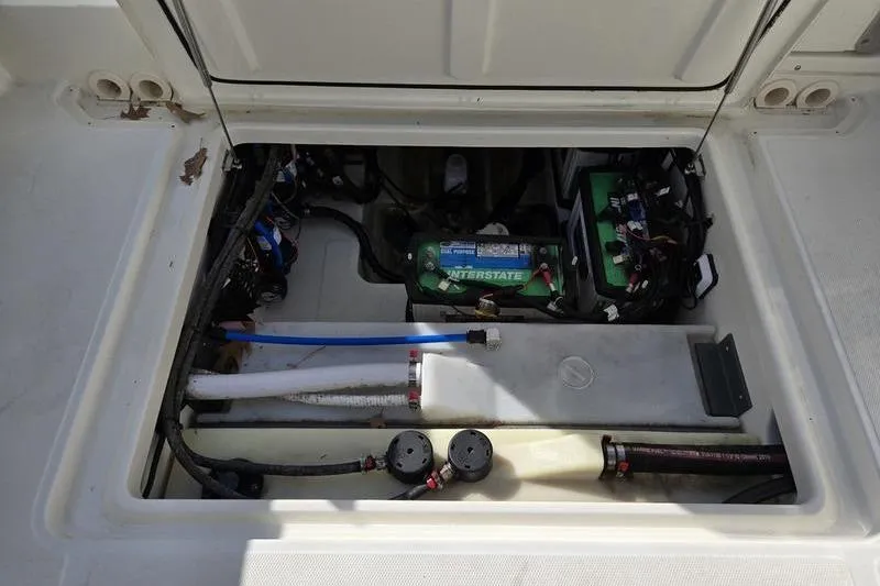 Slide: The Image of 2020 Boston Whaler 270 Vantage battery compartment with wiring and components. - 17