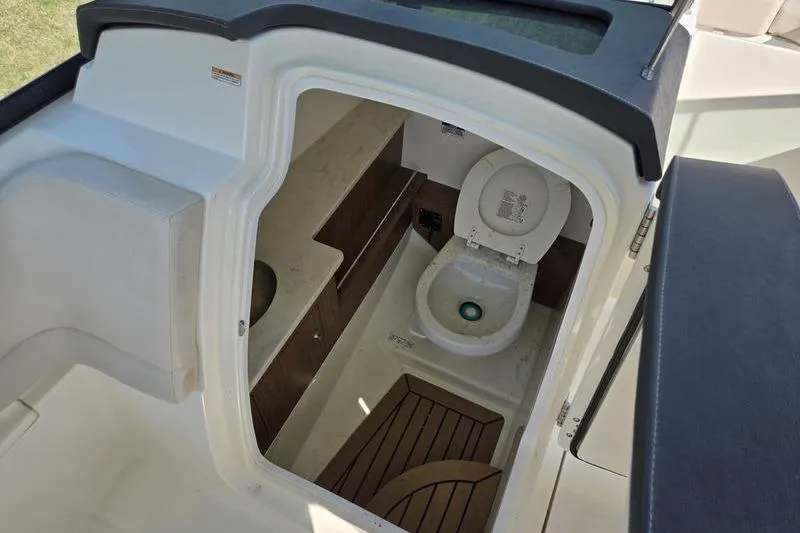 Slide: The Image of Interior view of 2020 Boston Whaler 270 Vantage boat's compact bathroom area. - 21