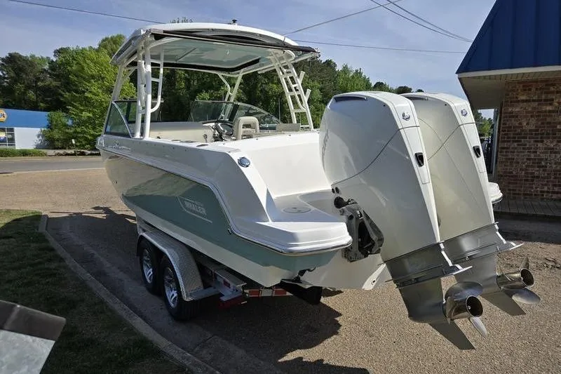 Slide: The Image of 2020 Boston Whaler 270 Vantage boat with dual engines on a trailer. - 5