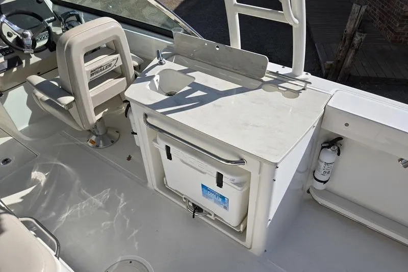 Slide: The Image of Interior of 2020 Boston Whaler 270 Vantage boat with seating and sink area. - 8