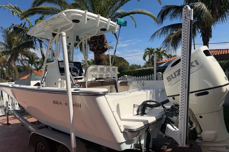 Slide: The Image of 2020 Sea Pro 219 Center Console boat with Suzuki engine, parked near palm trees. - 10