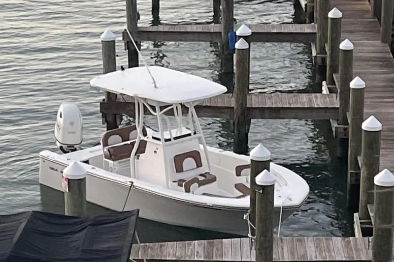 Slide: The Image of 2020 Sea Pro 219 Center Console boat docked at a marina. - 11