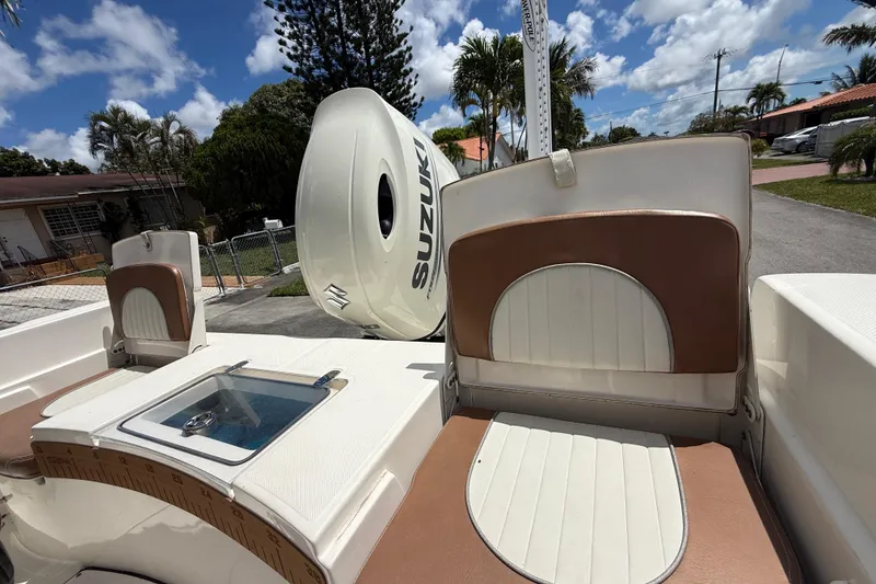 Slide: The Image of 2020 Sea Pro 210 Center Console boat with Suzuki outboard motor, parked outdoors. - 16