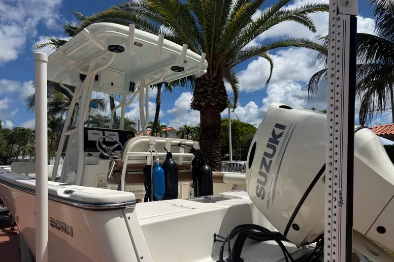 Slide: The Image of 2020 Sea Pro 210 Center Console boat with Suzuki engine, under palm trees. - 17