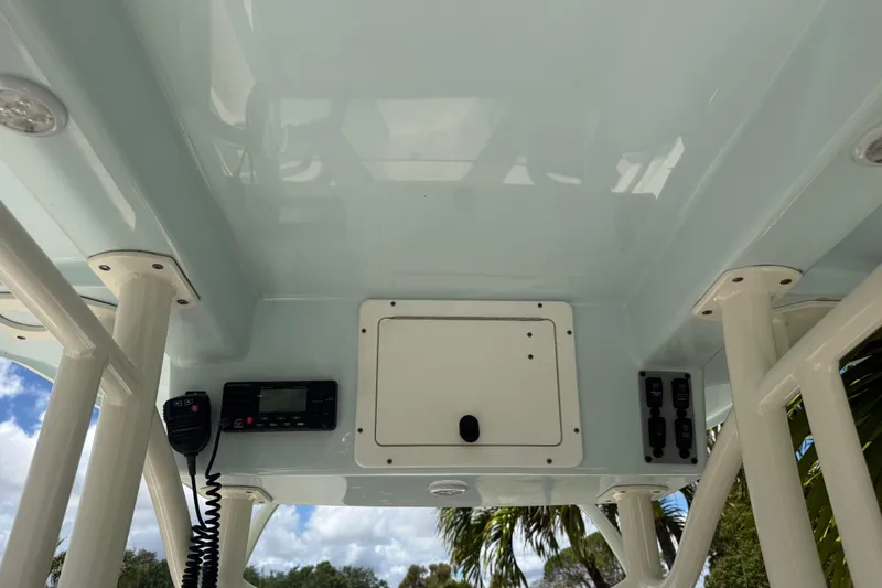 Slide: The Image of 2020 Sea Pro 210 Center Console boat's overhead console with radio and storage compartment. - 20