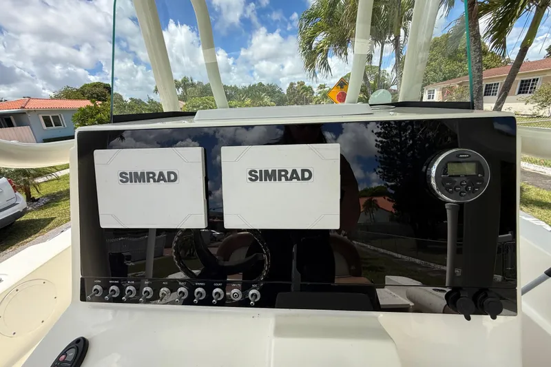 Slide: The Image of 2020 Sea Pro 210 Center Console dashboard with dual Simrad displays and control panel. - 23
