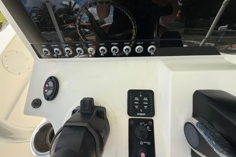 Slide: The Image of Control panel of a 2020 Sea Pro 210 Center Console boat with various switches and controls. - 24