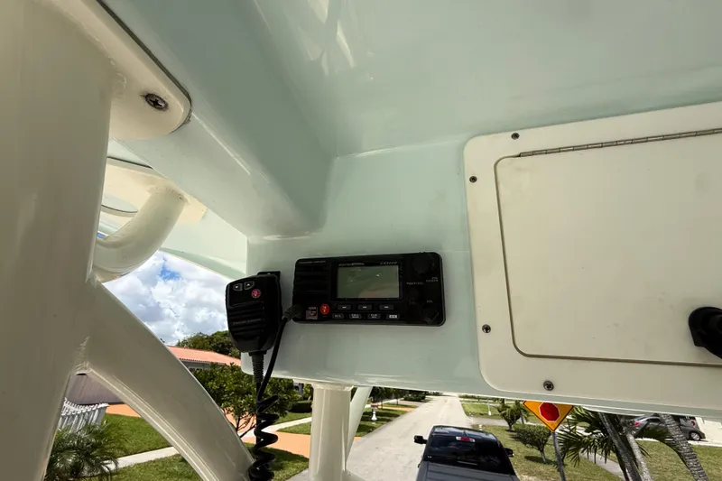 Slide: The Image of 2020 Sea Pro 210 Center Console boat interior with radio equipment and sunny sky. - 25