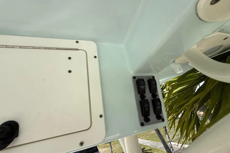 Slide: The Image of Control panel on a 2020 Sea Pro 210 Center Console boat, featuring switches and a hatch. - 27