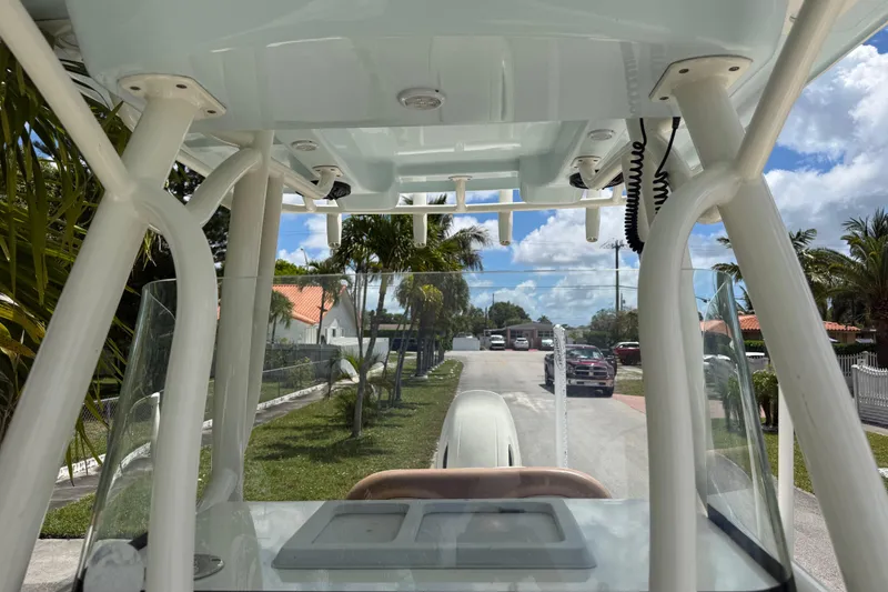 Slide: The Image of 2020 Sea Pro 210 Center Console boat parked on a sunny residential street. - 28