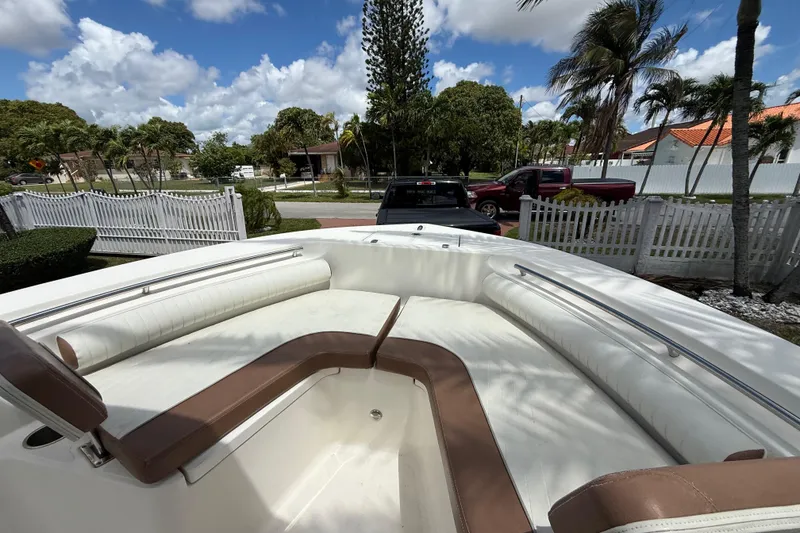 Slide: The Image of 2020 Sea Pro 210 Center Console boat with spacious seating, parked in a residential area. - 31