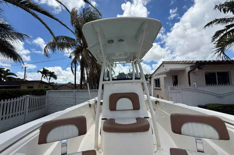 Slide: The Image of 2020 Sea Pro 210 Center Console boat with palm trees and houses in the background. - 32