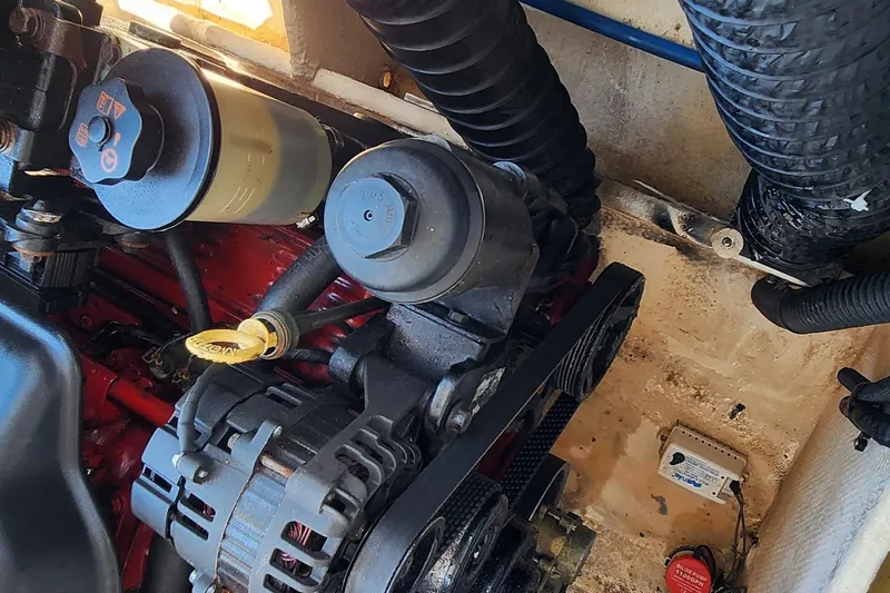 Slide: The Image of Engine compartment of a 2010 Regal 2700 ES Bowrider, showing mechanical components and hoses. - 13