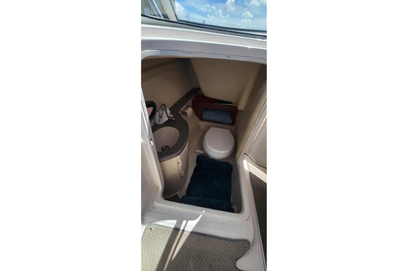 Slide: The Image of 2010 Regal 2700 ES Bowrider interior with compact bathroom and sink. - 15