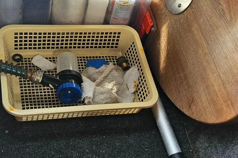 Slide: The Image of Storage basket with cleaning supplies on a 2010 Regal 2700 ES Bowrider boat. - 16