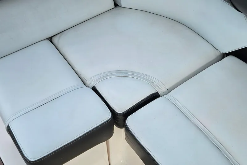 Slide: The Image of White cushioned seating on a 2010 Regal 2700 ES Bowrider boat. - 19