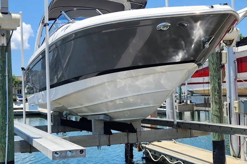 Slide: The Image of 2010 Regal 2700 ES Bowrider on a boat lift, docked at a marina. - 3