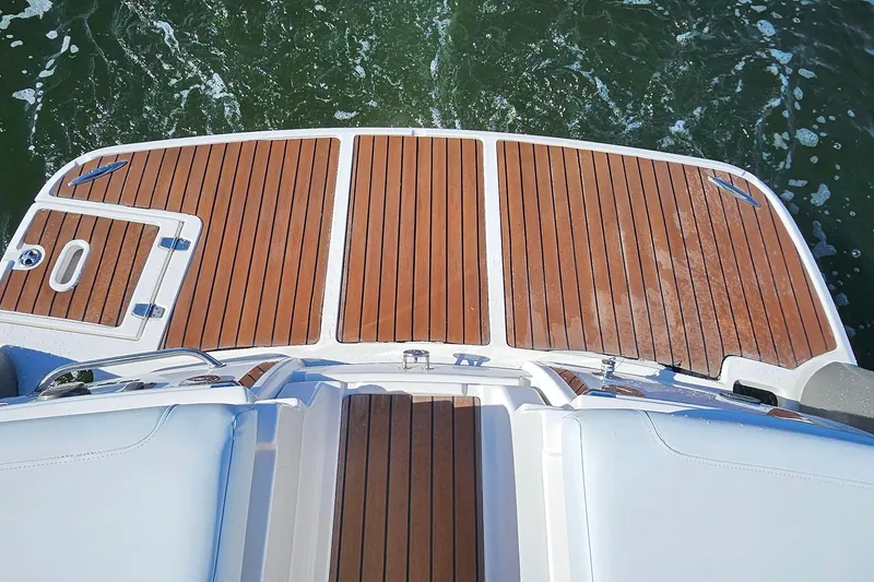 Slide: The Image of 2010 Regal 2700 ES Bowrider swim platform with teak decking on water. - 31