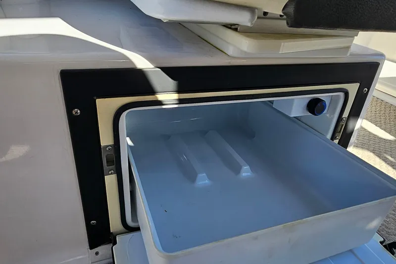 Slide: The Image of Open storage compartment on 2010 Regal 2700 ES Bowrider boat. - 36