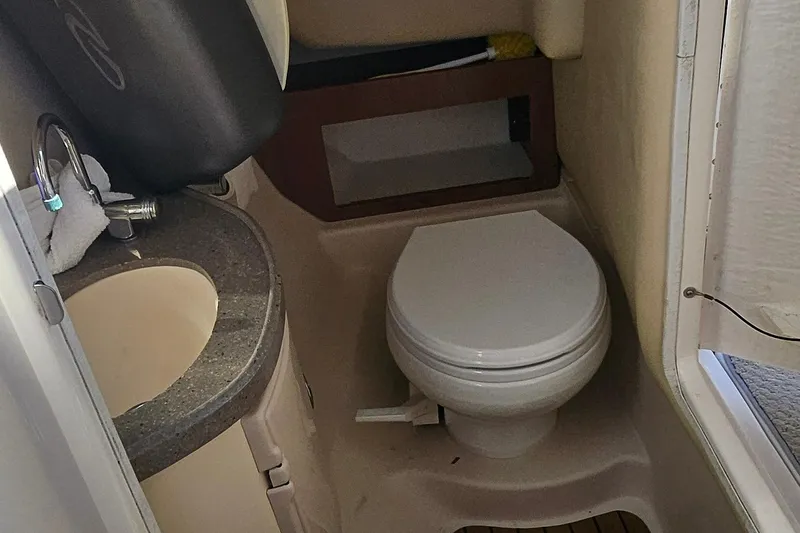 Slide: The Image of 2010 Regal 2700 ES Bowrider boat bathroom with sink and toilet. - 41