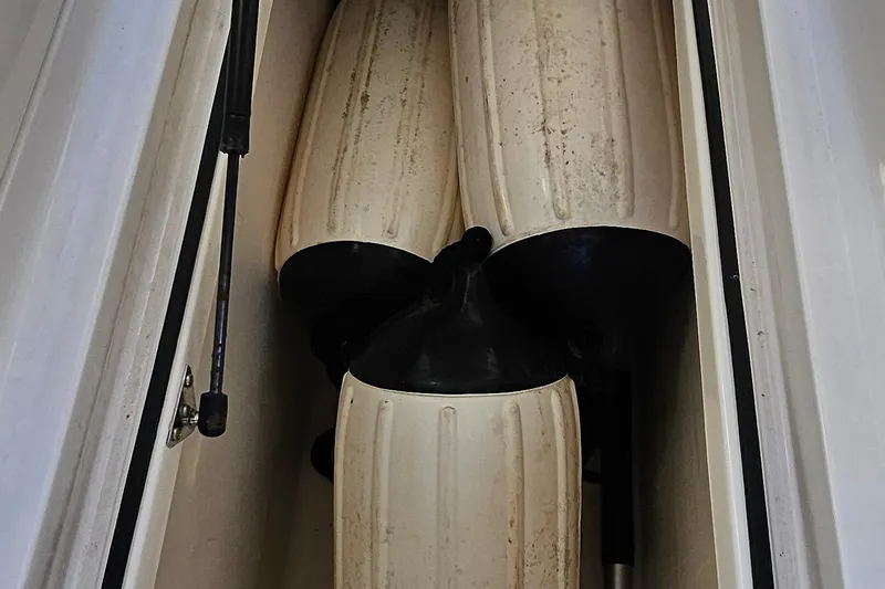 Slide: The Image of Boat fenders stored in a compartment of a 2010 Regal 2700 ES Bowrider. - 43
