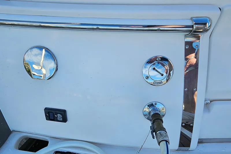 Slide: The Image of 2010 Regal 2700 ES Bowrider boat fuel and waste access panel. - 61