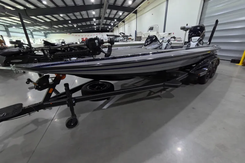 The Image of 2025 Skeeter boat on trailer in indoor showroom setting. - 1