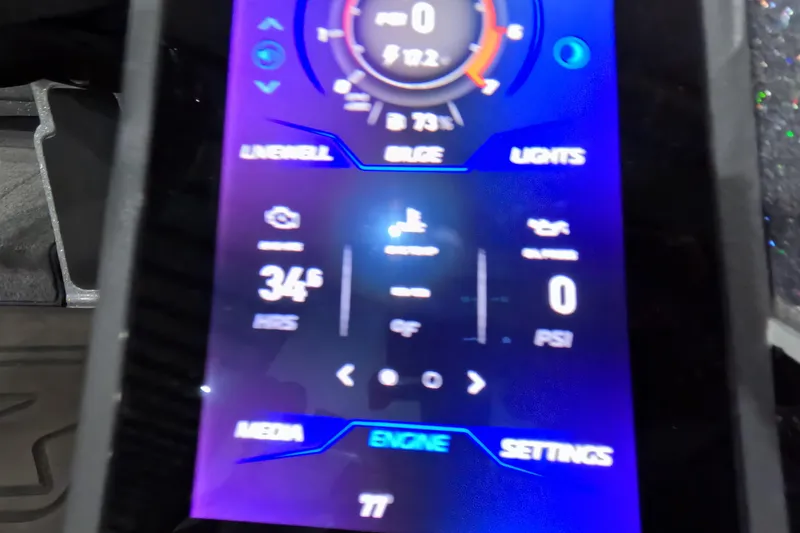 Slide: The Image of Close-up of a 2025 Skeeter boat control panel displaying engine and system settings. - 16