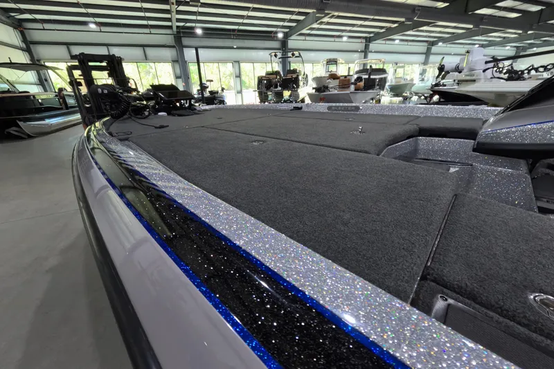 Slide: The Image of 2025 Skeeter boat interior with glitter finish, showcased in a spacious showroom. - 4
