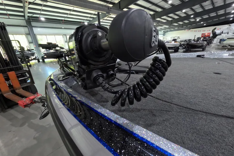 Slide: The Image of 2025 Skeeter boat with trolling motor in showroom, featuring sleek design and advanced technology. - 7